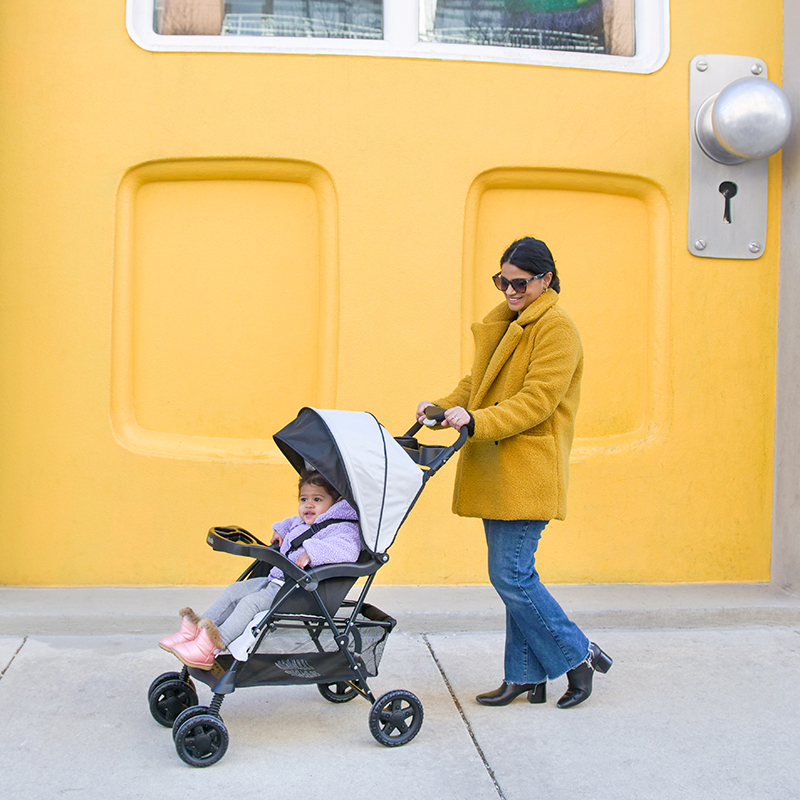 Mom with toddler in the award-winning Kolcraft Cloud Plus stroller
