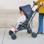 toddler in kolcraft umbrella stroller