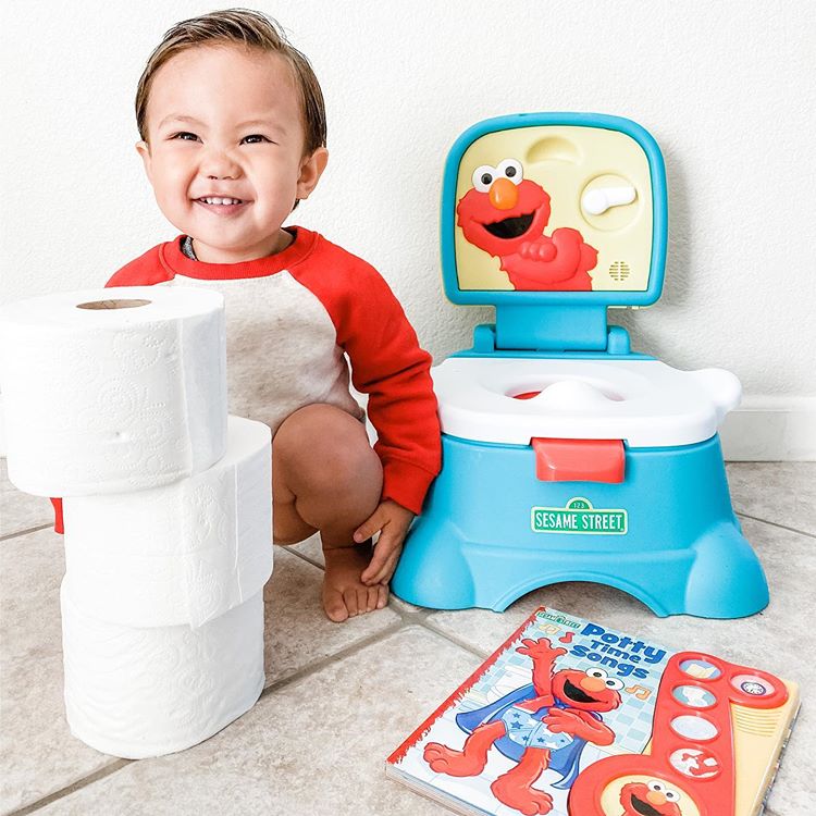 toddler sitting next to the Elmo! potty