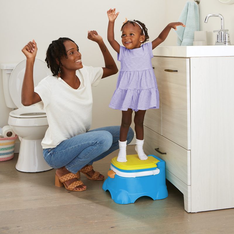 toddler standing on the potty step stool