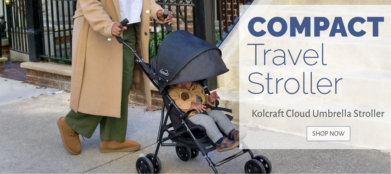 Parent and child strolling with Kolcraft Compact Travel Stroller